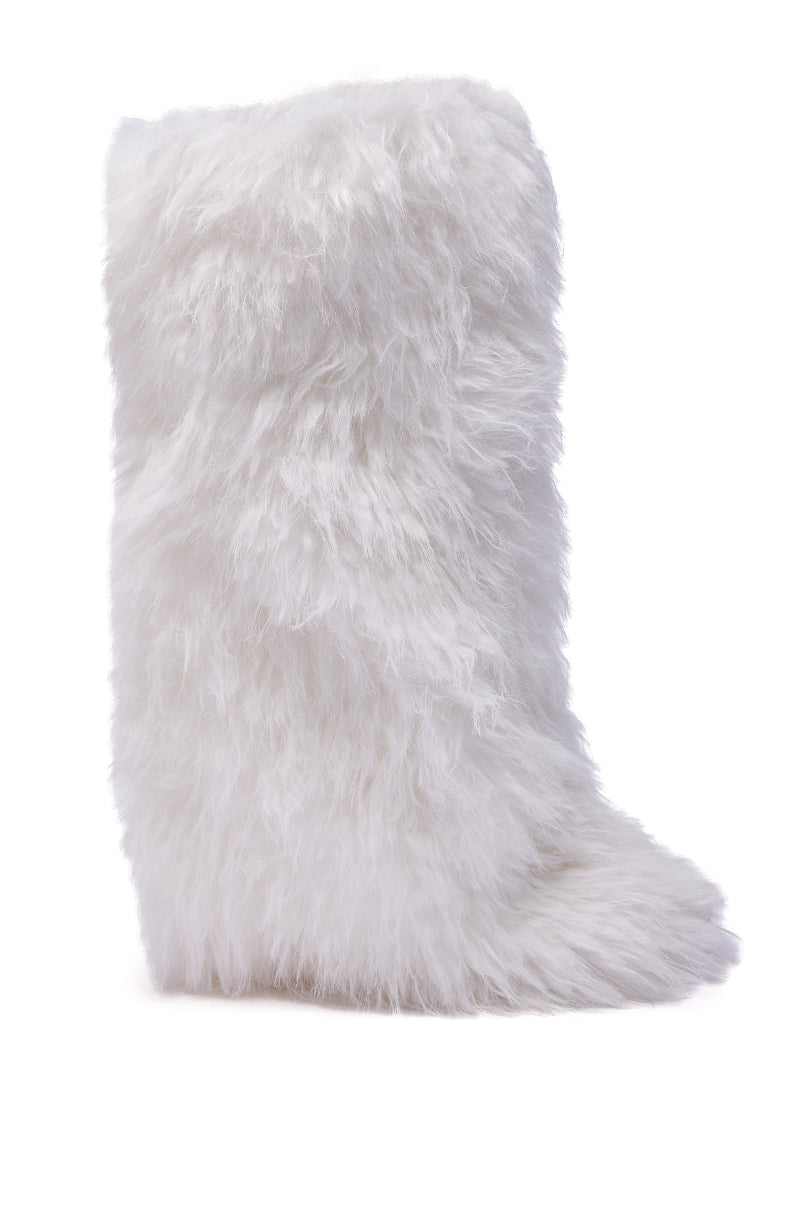The AZALEA WANG ARETE WHITE FUR STILETTO BOOT is a knee-high faux fur boot with a pointed toe and stiletto heel, featuring fluffy white fur and displayed from the side on a white background.