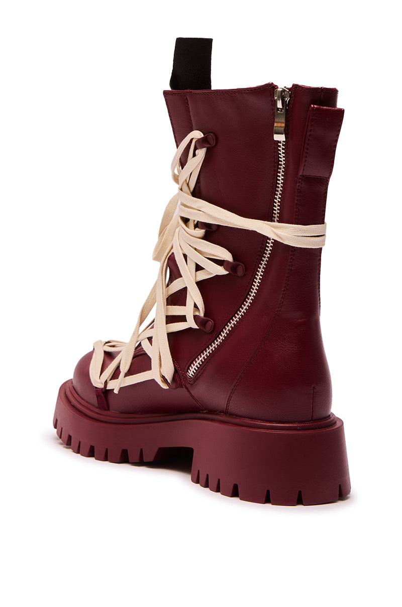 The AZALEA WANG ARJUN BURGUNDY LACE DETAIL BOOTIE features burgundy leather, a chunky platform lug sole, cream crisscross laces, side zipper, and black heel pull tab, displayed against a white background.