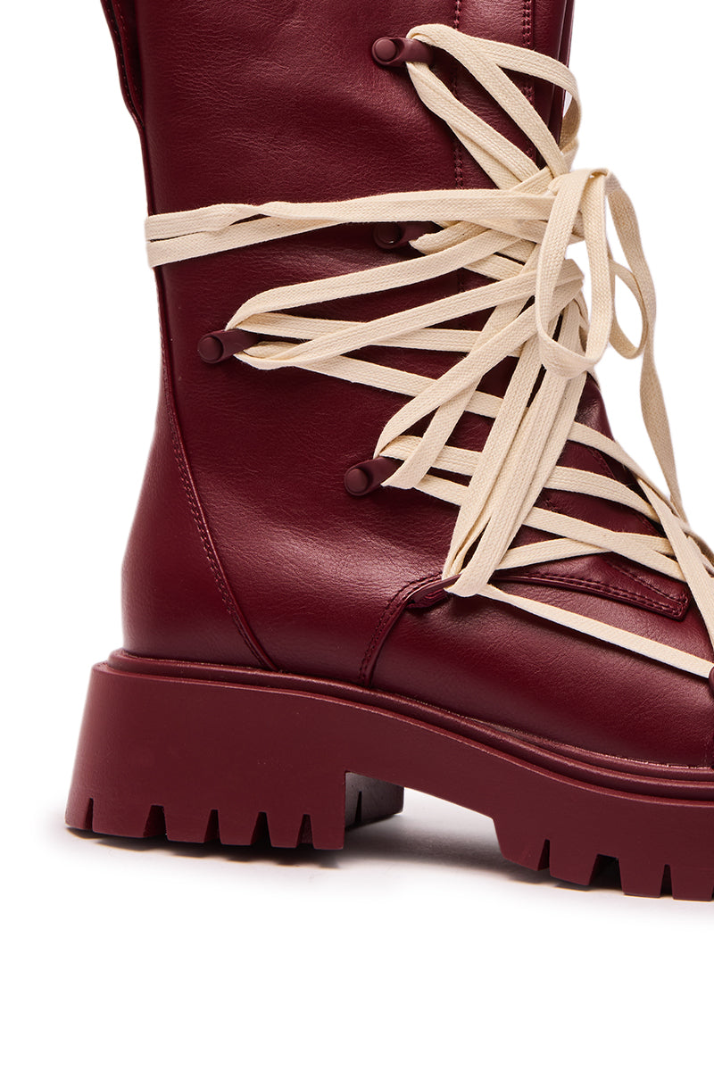 A close-up of the AZALEA WANG ARJUN BURGUNDY LACE DETAIL BOOTIE, featuring maroon faux leather, thick beige crisscross laces, and a chunky ridged sole.