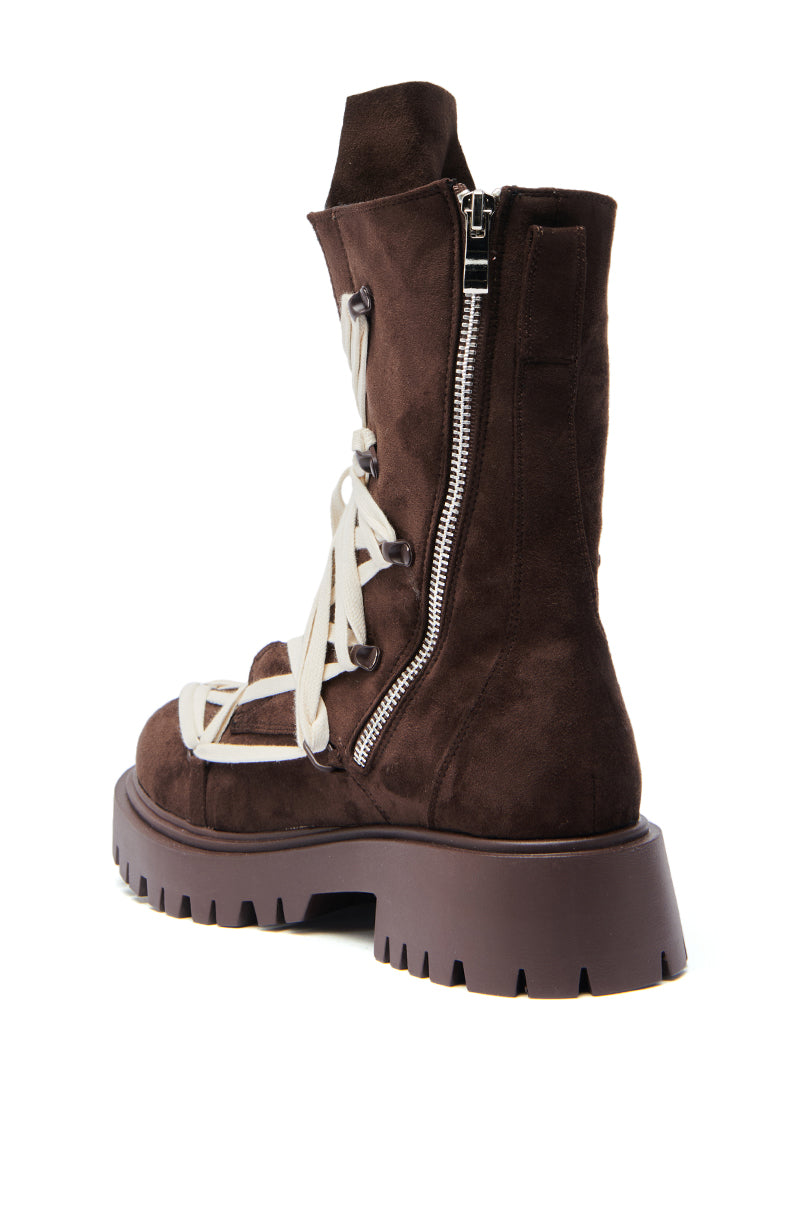 The AZALEA WANG ARJUN CHOCOLATE LACE BOOTIE features faux suede, a chunky heel, thick ridged sole, white laces, and a silver side zipper, displayed against a white background.