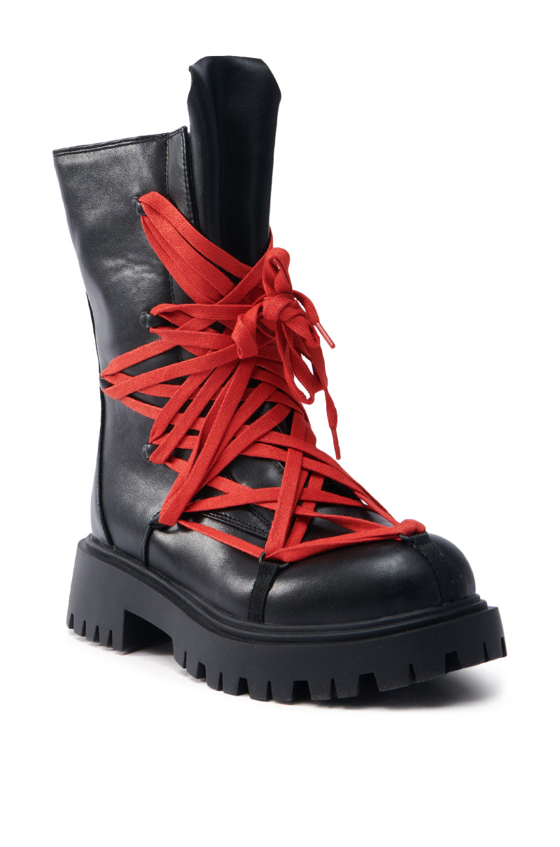 The AZALEA WANG ARJUN Lace Detail Combat Bootie is a black, high-top boot crafted from vegan leather, featuring thick red crisscrossing laces and a rugged sole.
