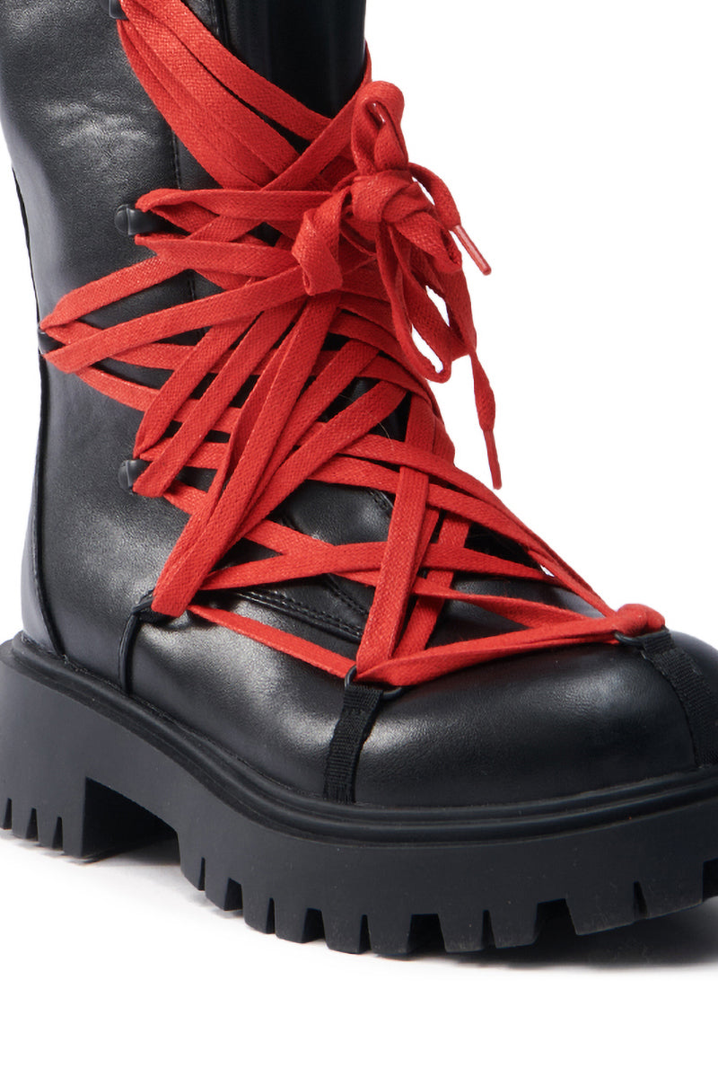 Close-up of the AZALEA WANG ARJUN Lace Detail Combat Bootie in black with red laces crisscrossed over the front, crafted from vegan leather and featuring a chunky, ridged sole.