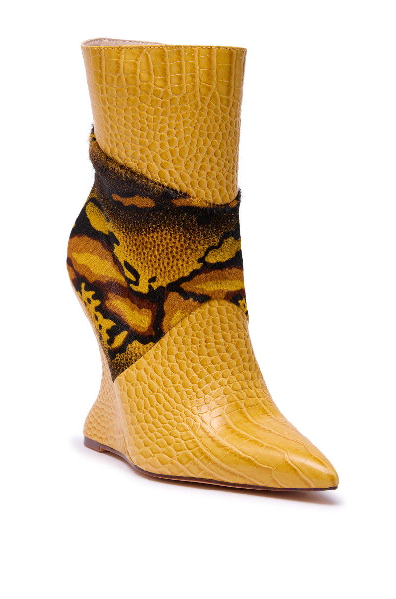 The AZALEA WANG ARTOUL Yellow Color Blocked Wedge Bootie features high heels, pointed toes, yellow crocodile-textured faux leather, and bold abstract tiger-print fur accents around the ankle and heel.