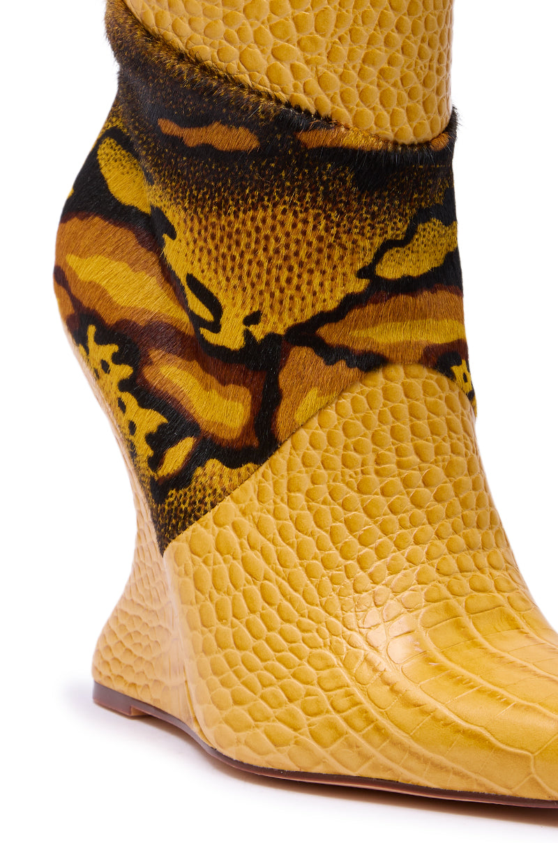 Close-up of the AZALEA WANG ARTOUL YELLOW COLOR BLOCKED YELLOW WEDGE BOOTIE, featuring a textured snakeskin print, black and brown abstract ankle design, sculpted faux leather shape, and smooth sole.
