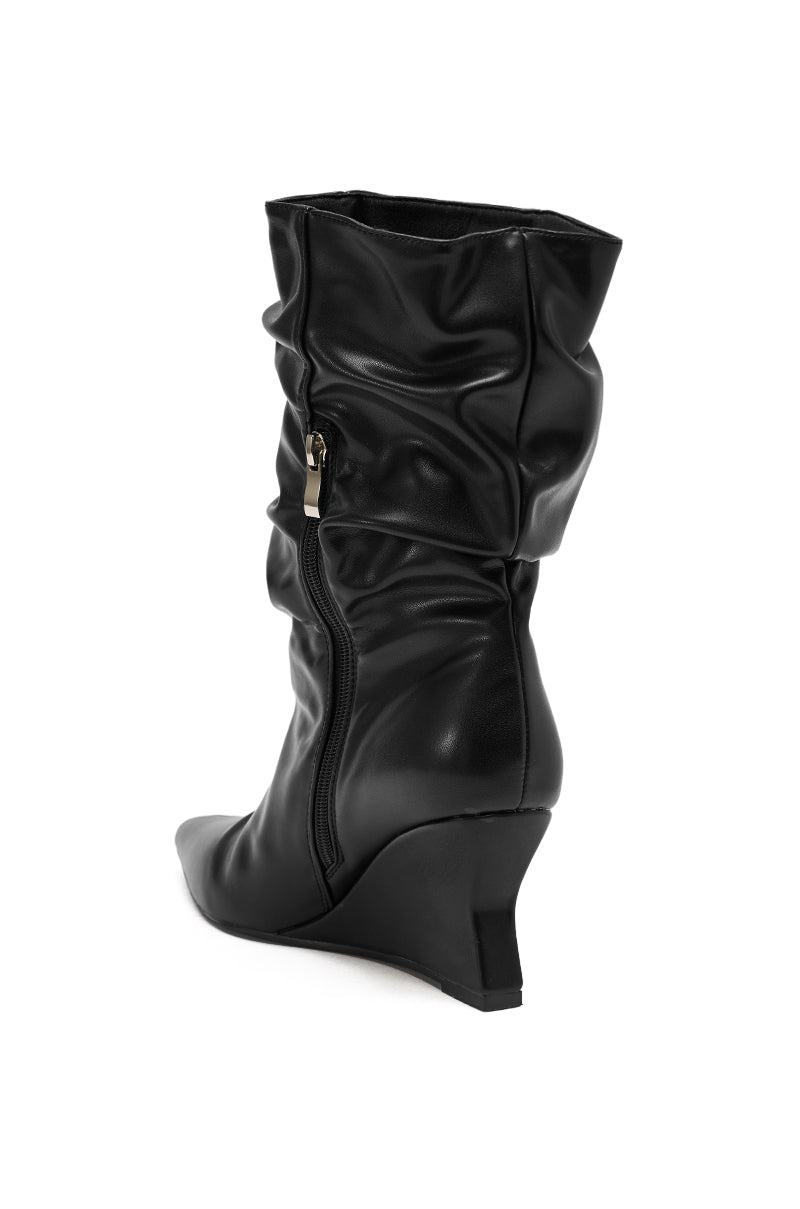 The AZALEA WANG ASAF Ruched Wedge Bootie in black faux leather features a mid-calf height, side zipper, and wedge heel, shown from the rear on a white background.