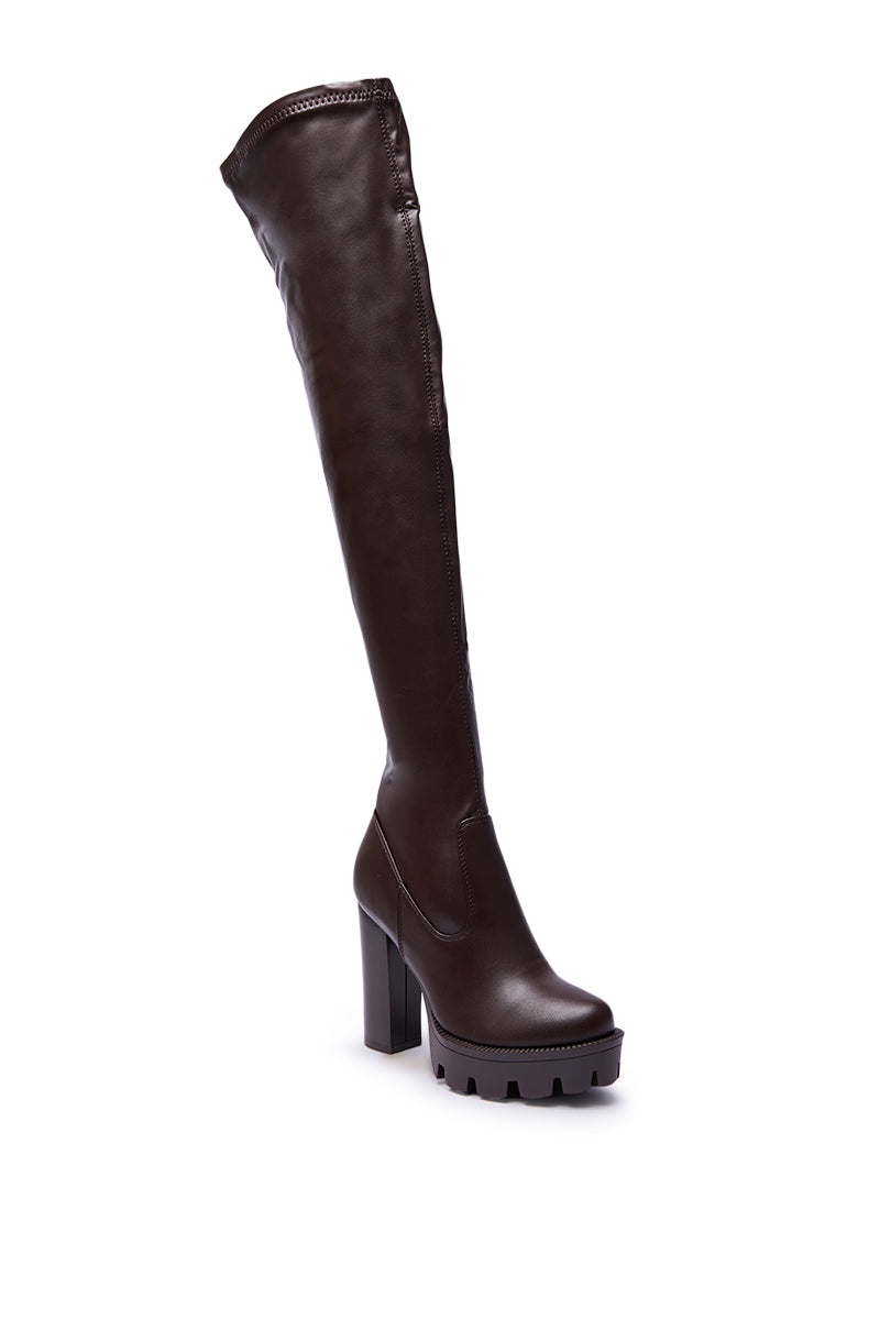 The AZALEA WANG ASHLAND Chocolate Stretch PU Chunky Thigh-High Boot features a platform sole, chunky heel, almond toe, and smooth finish, showcased against a white background.