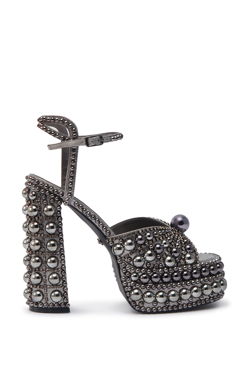 The AZALEA WANG ASTRELLA HEMATITE EMBELLISHED SANDAL features a chunky heel, platform sole, ankle strap, plus silver studs and large pearl-like accents for standout style.
