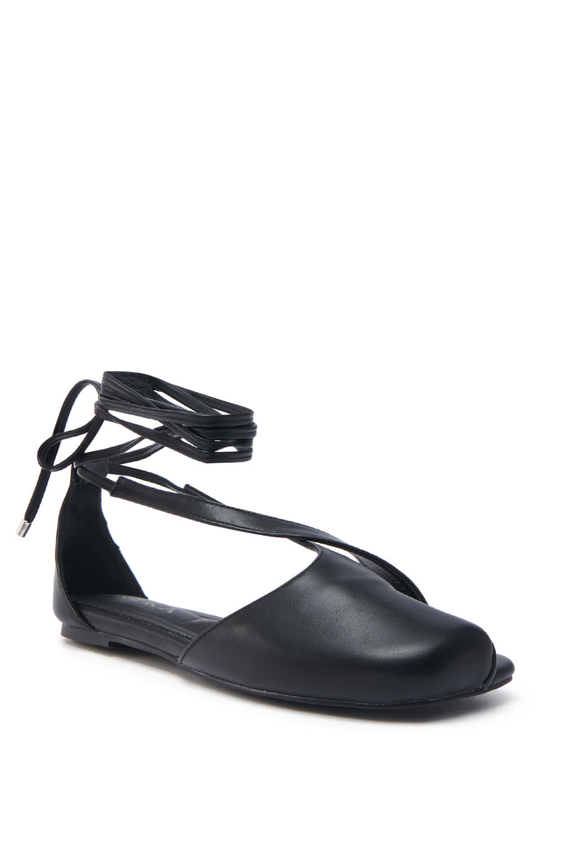 The AKIRA AULORA BLACK FLAT SANDAL combines a peep toe and lace-up ankle strap in vegan leather, boasting a sleek finish with a cushioned insole for elegance and versatility on any occasion.