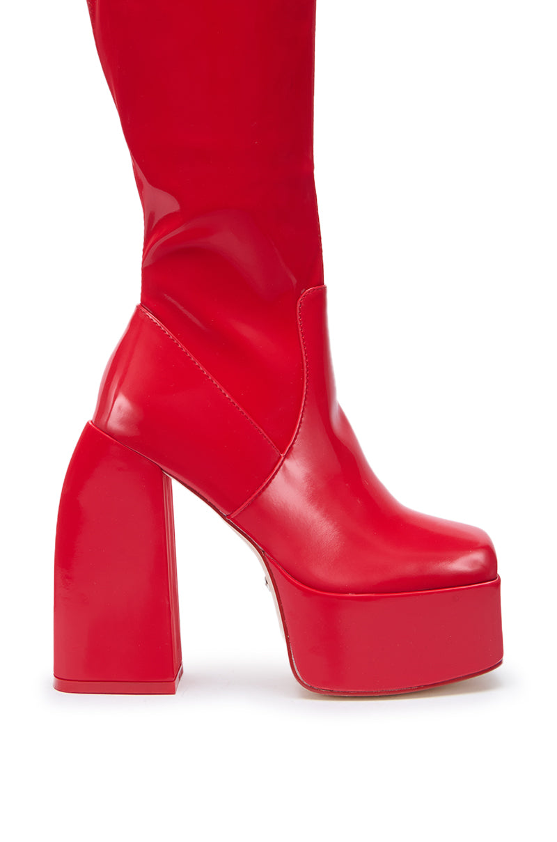 The AZALEA WANG AURON Red Liquid Luxe Platform Boot features shiny red faux patent leather, a chunky high heel, and a square toe, shown from the side against a white background.