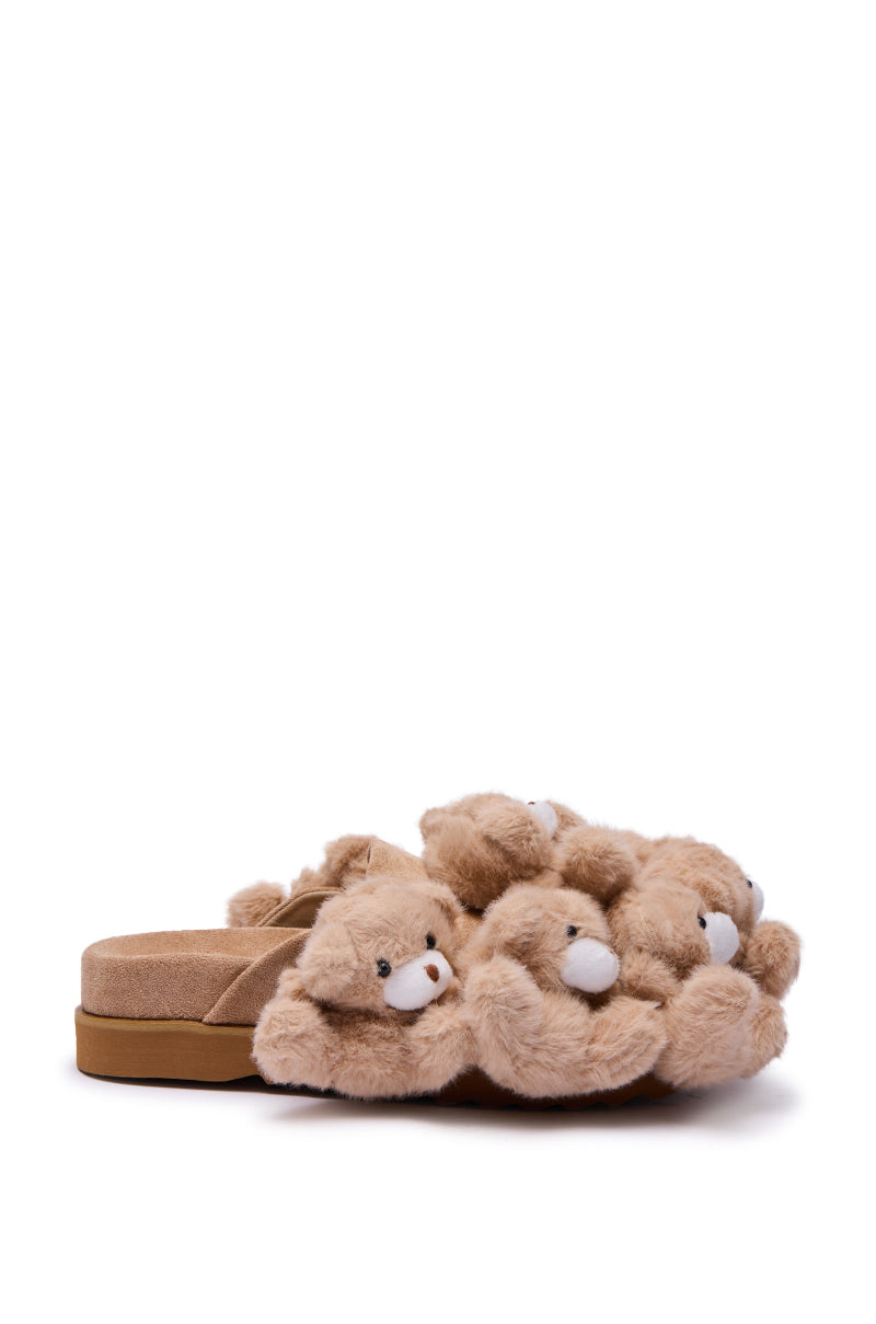 A side view of the AZALEA WANG AURORA BEIGE TEDDY BEAR CLOG, faux suede slides with multiple plush 3D light brown teddy bears on the upper and a tan sole, shown against a plain white background.