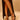 A person in a black high-slit dress showcases their legs and wears AZALEA WANG AVENA BLACK PAT SANDAL—black vegan leather heels with thin straps and a square toe—while standing against a plain beige background.