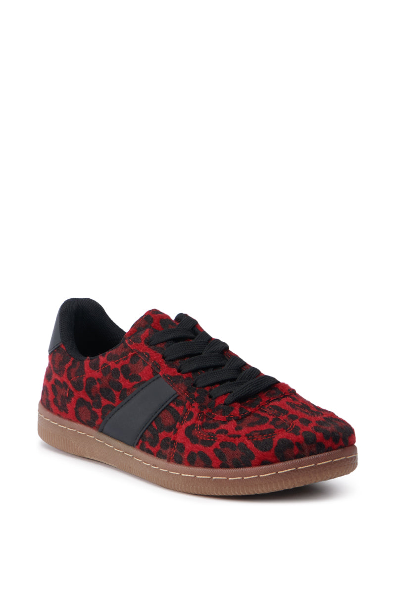Introducing the AZALEA WANG AVENGER RED LEOPARD SNEAKER, showcasing a bold red and black leopard print enhanced by a faux pony hair texture. This low-cut sneaker features a lace-up vamp with sleek black laces and stripe, all resting on a durable brown rubber sole for exceptional comfort and style.