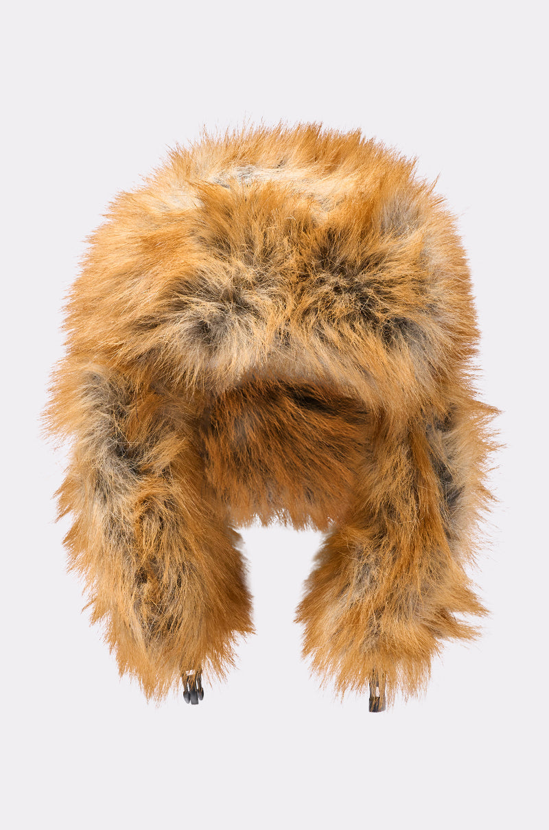 The SO WITH IT FAUX FUR AVIATOR HAT features fluffy brown and black faux fur, cozy ear flaps, and quilted lining, showcased against a plain light gray background. 9