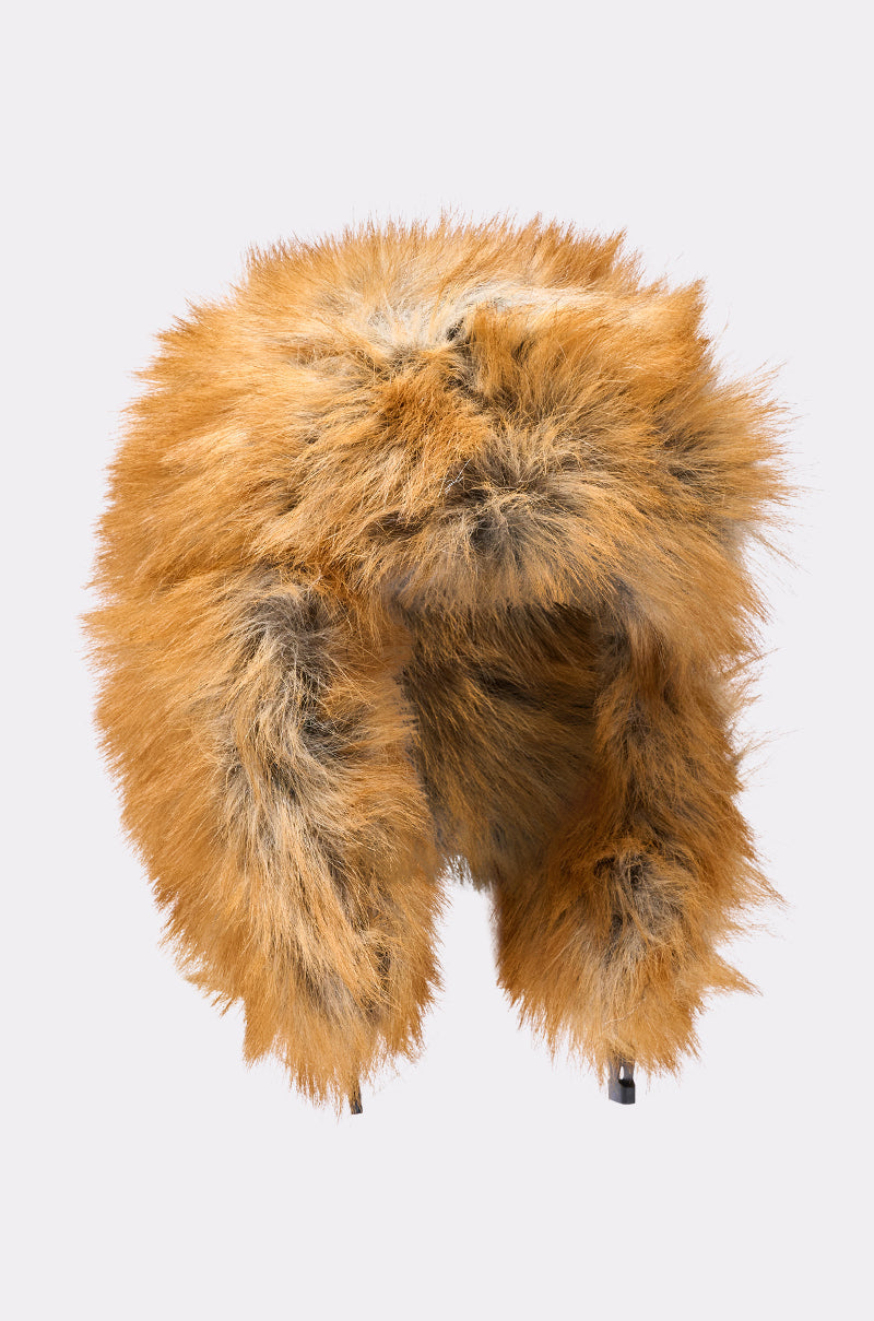 The SO WITH IT FAUX FUR AVIATOR HAT features fluffy brown and orange faux fur, cozy quilted lining, ear flaps, and an animal fur look, shown against a plain light background. 10
