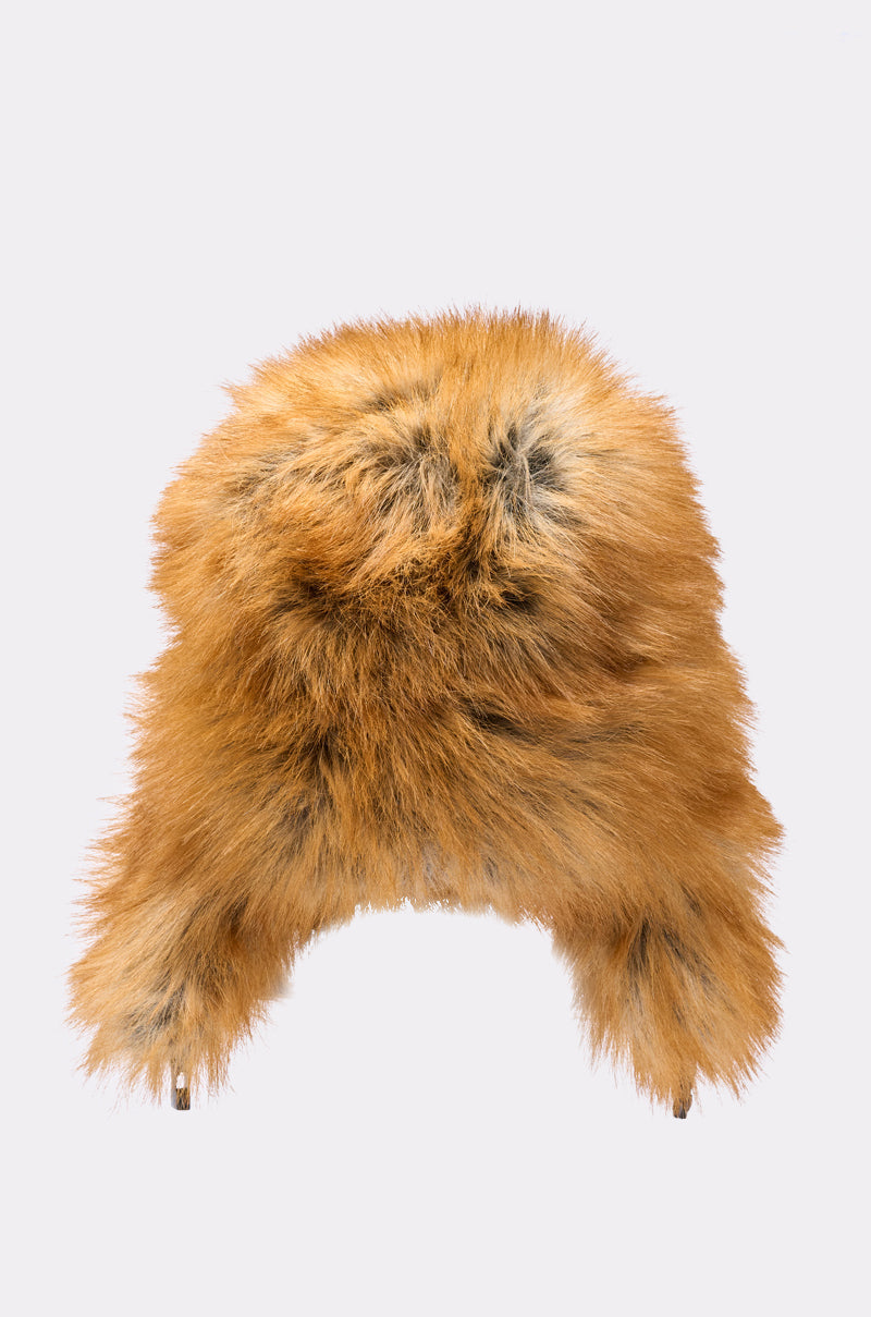 The SO WITH IT FAUX FUR AVIATOR HAT features fluffy brown and orange faux fur, ear flaps, and a cozy quilted lining, shown against a simple light background. 11