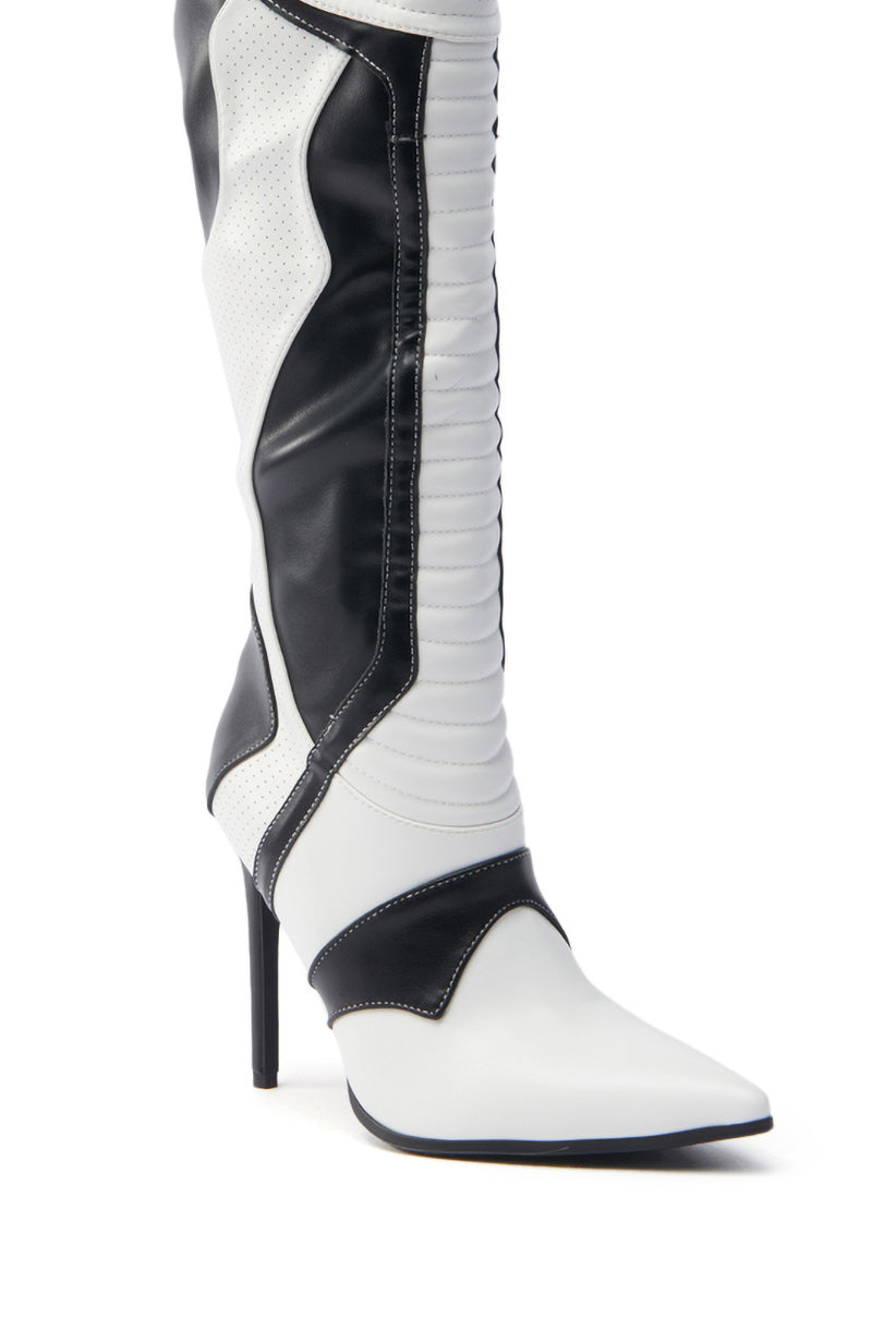The AZALEA WANG RODRIGO BLACK AND WHITE BOOT STILETTO features a sleek design with a pointed toe in vegan leather, alternating black and white panels, intricate side and front stitch detailing, and a tall stiletto heel.