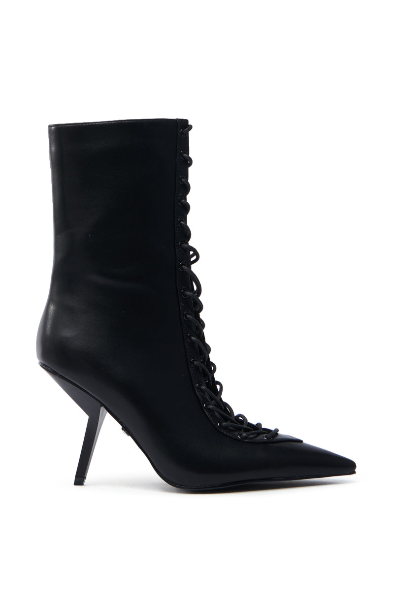 The AZALEA WANG SILVA BLACK LACE UP STILETTO BOOTIE features a sleek black faux leather design with a pointed toe, side lace-up detail, and unique angled heel.