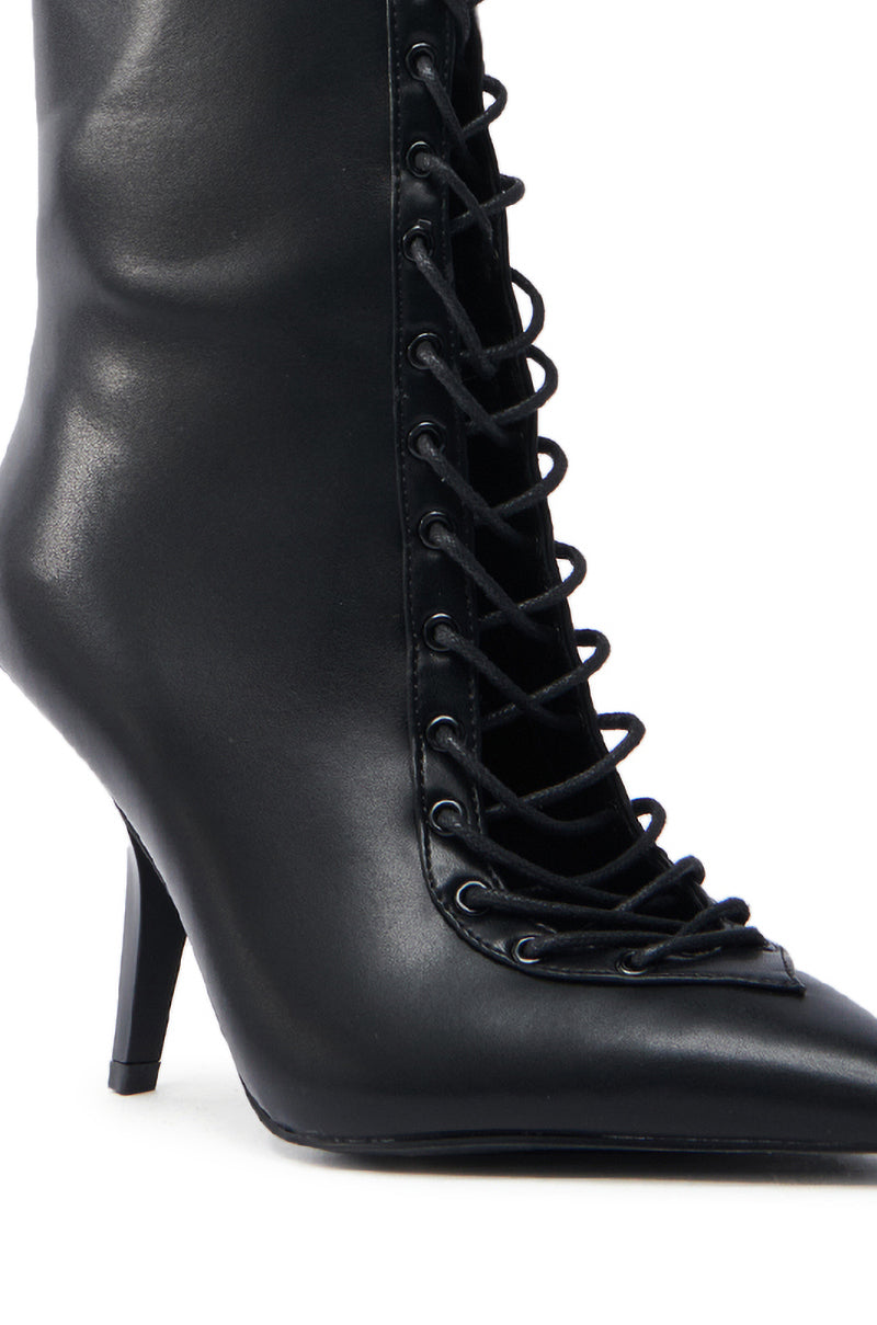 Close-up of the AZALEA WANG SILVA BLACK LACE UP STILETTO BOOTIE, a chic faux leather ankle boot featuring a pointed toe and front lacing with black laces through metal eyelets.