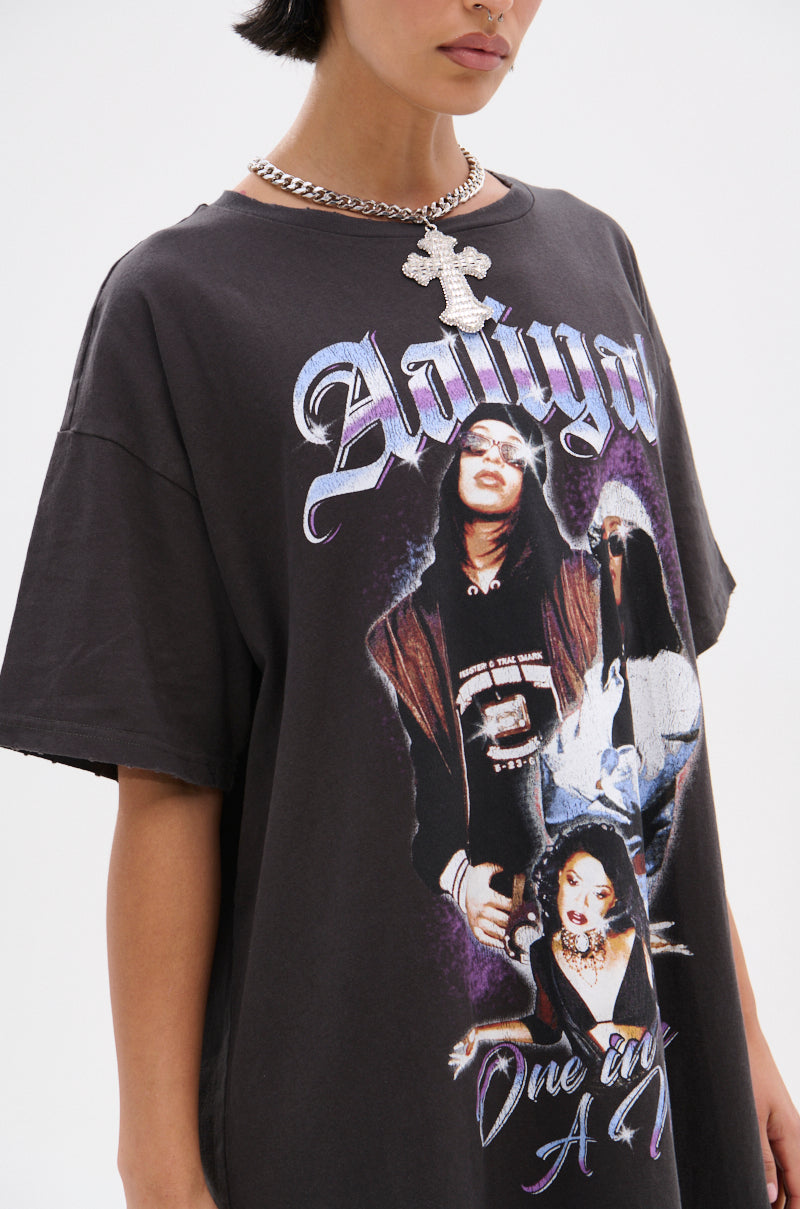 Wearing the AALIYAH FOREVER GRAPHIC TSHIRT DRESS with images and "One in A Million" text—an iconic tribute styled with a bold chain necklace, perfect for elevating your streetwear look.