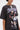 Wearing the AALIYAH FOREVER GRAPHIC TSHIRT DRESS with images and "One in A Million" text—an iconic tribute styled with a bold chain necklace, perfect for elevating your streetwear look.