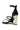 The AZALEA WANG AYYAR BLACK GOLD WEDGE HEEL SANDAL features thin straps, an ankle strap with buckle, and a shiny gold wedge heel, all crafted from luxe faux leather for a chic and modern finish.