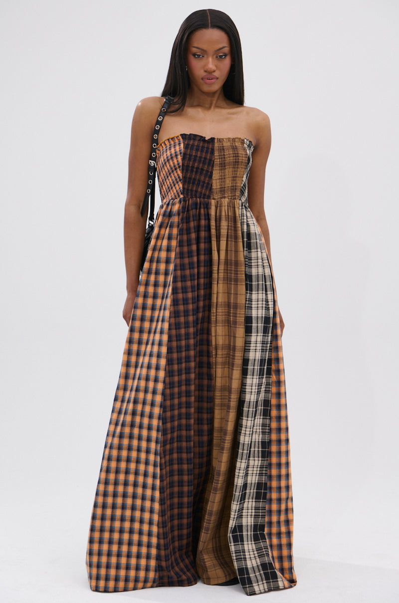 Channeling punk princess vibes, she rocks the FALL IN LOVE PLAID MAXI DRESS in brown, black, and beige. Straight hair and a black shoulder bag with silver grommets add a chic, 90’s-inspired touch.