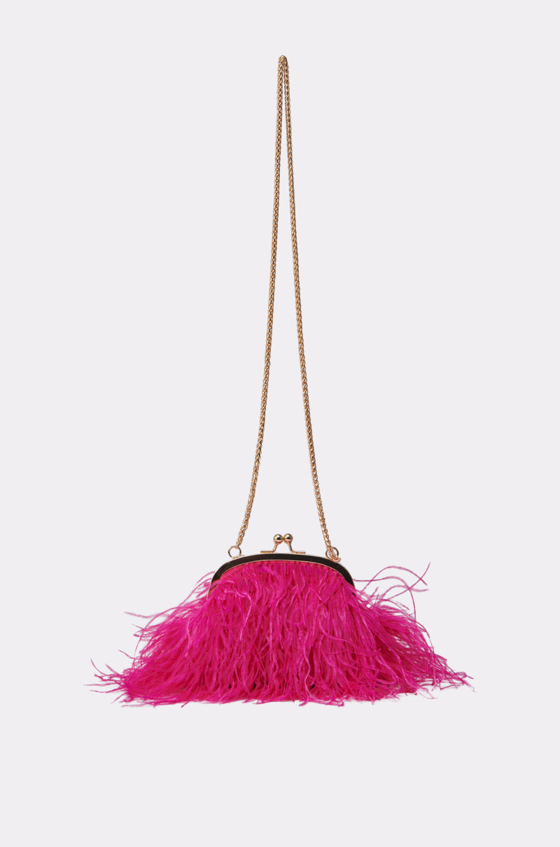 The TICKLED PINK PURSE is a small, bright pink bag with fuchsia feathers, gold chain strap, and clasp closure, shown against a plain white background. 1