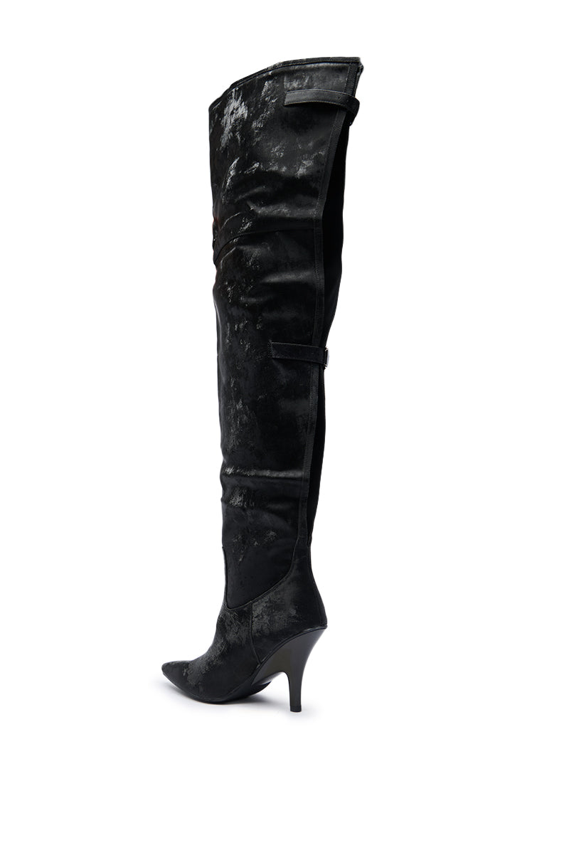 The AZALEA WANG BACKER BLACK SHINE OVER THE KNEE BOOT is shown in profile on a white background, featuring black faux leather, a pointed toe, and a textured, slightly shiny finish.