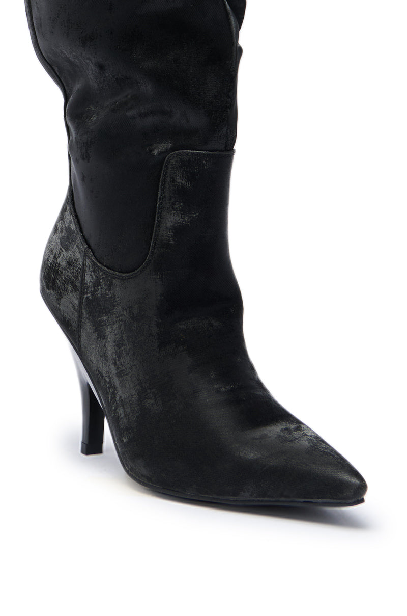 A close-up of the AZALEA WANG BACKER BLACK SHINE OVER THE KNEE BOOT, featuring black faux leather, a pointed toe, stiletto heel, and slouchy shaft, shown against a white background.