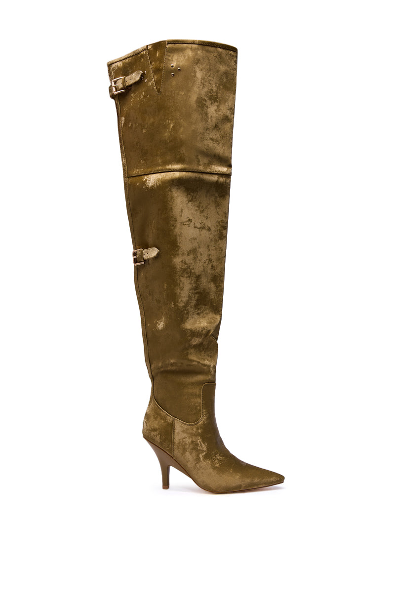 The AZALEA WANG BACKER KHAKI SHINE OVER THE KNEE BOOT is a single knee-high, pointed-toe boot in distressed gold faux leather, featuring a mid stiletto heel and buckle details at the top and ankle.