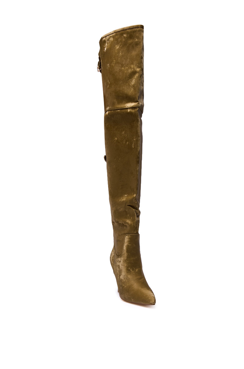 The AZALEA WANG BACKER KHAKI SHINE OVER THE KNEE BOOT features a pointed toe, slouchy faux leather design, and stiletto heel in shimmering gold, shown over a plain white background.