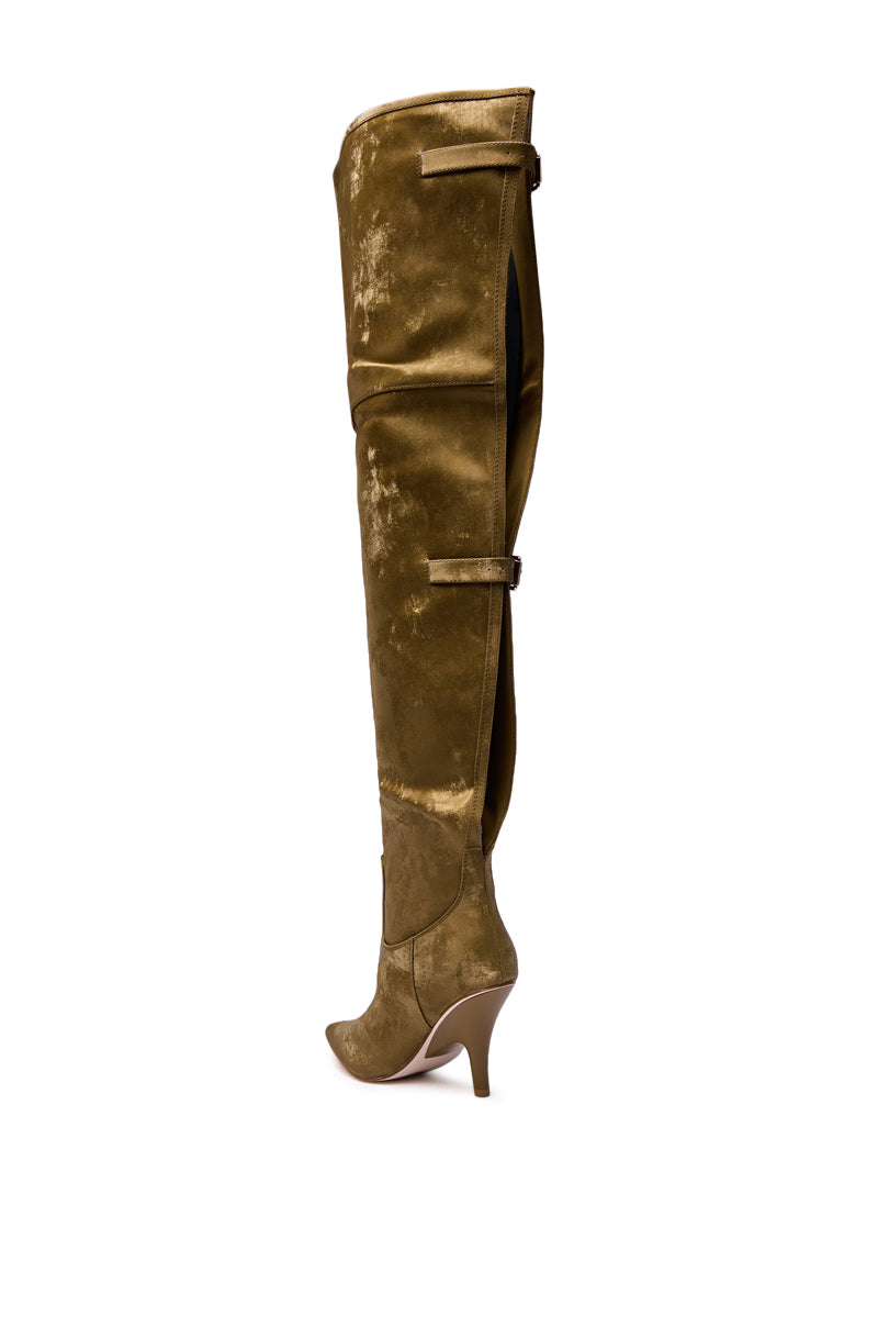 The AZALEA WANG BACKER KHAKI SHINE OVER THE KNEE BOOT is a single knee-high, pointed-toe boot in shiny olive green faux leather with two horizontal straps and a high curved stiletto heel, shown in profile on a white background.