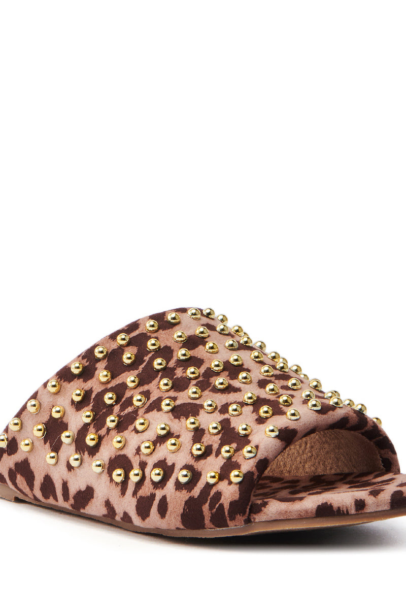 Introducing the AKIRA BAGGER Studded Slip-On Sandal in Leopard, featuring a chic open toe design with a striking brown and beige leopard print. Embellished with gold studs on the upper surface, it comes with a flat rubber sole for comfort and style.