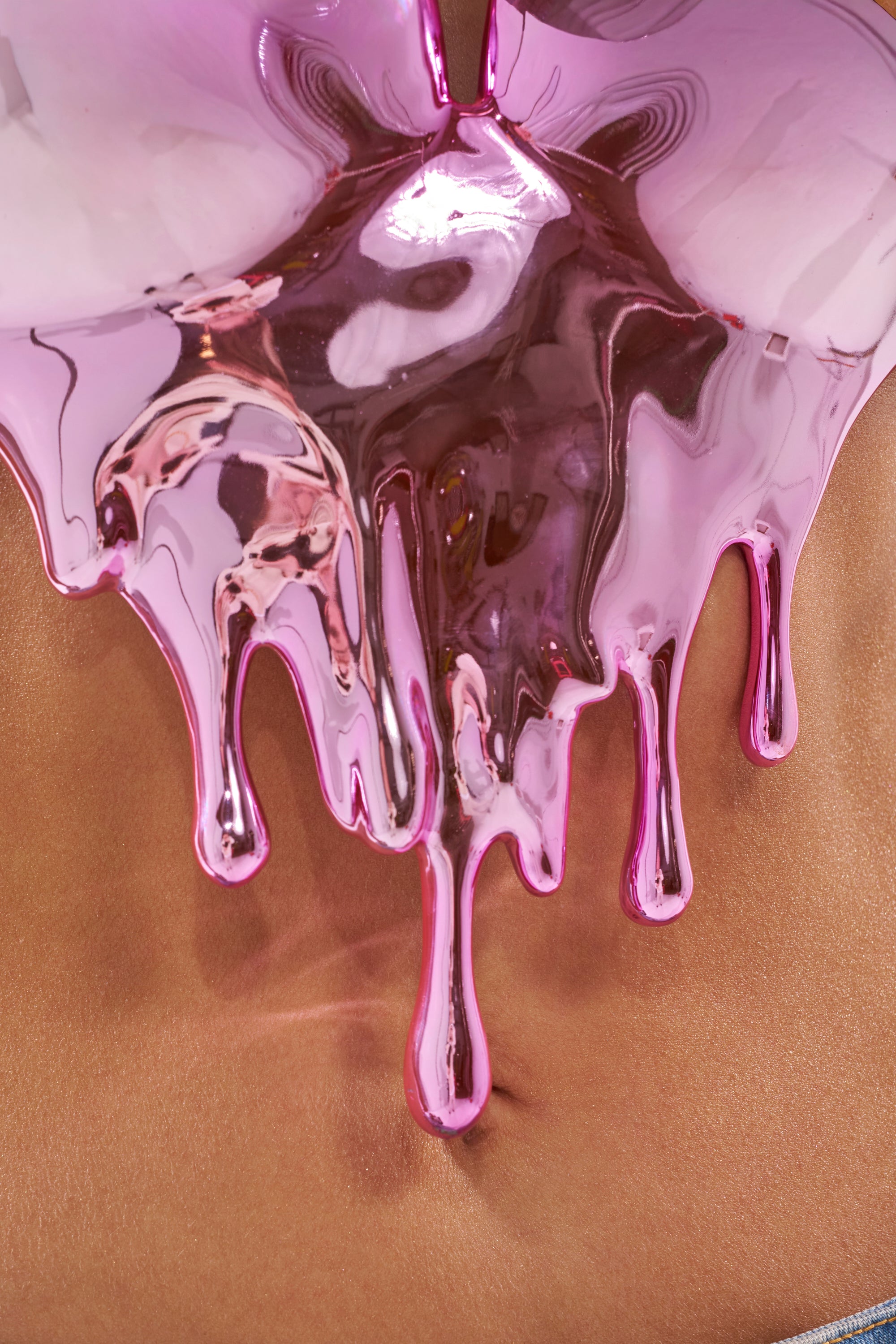 Close-up of shiny pink metallic liquid dripping over bare skin, highlighting its texture and navel—evoking the bold spirit of the DRIPPED OUT TOP. 10