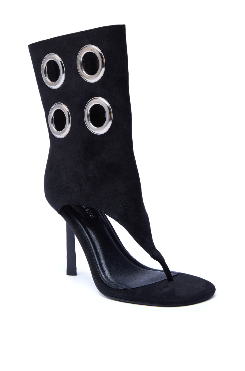 The AZALEA WANG BAINA BLACK GROMMET DETAIL GLADIATOR SANDAL has an open toe, high ankle cuff, and two rows of bold grommets, finished with a sleek stiletto heel for a modern, edgy look.