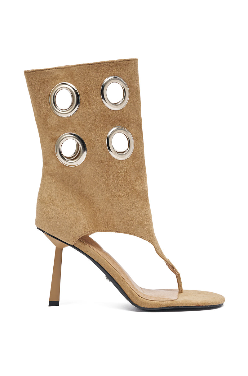 The AZALEA WANG BAINA TAN SILVER HARDWARE STILETTO SANDAL features tan faux suede, a square open toe, tall ankle cuff with four large silver grommets, and a slim stiletto heel.