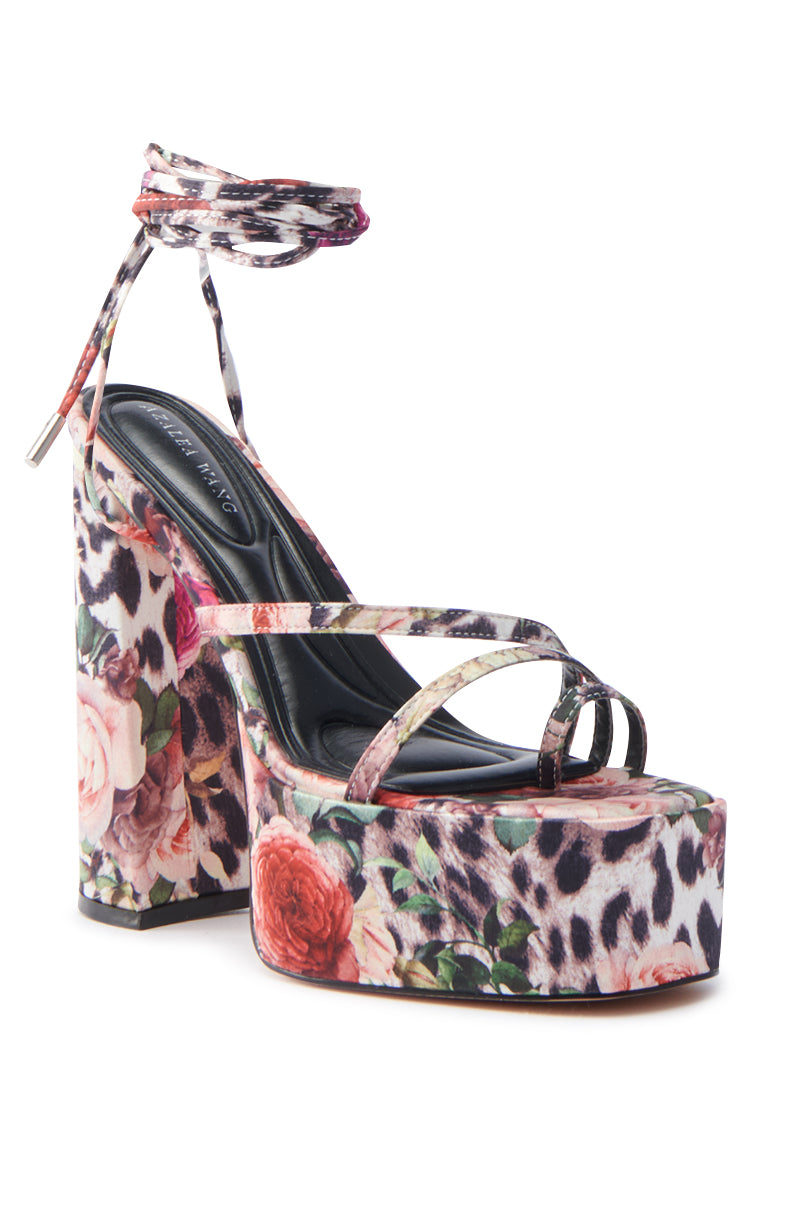 The AZALEA WANG BANIRA MULTI CHEETAH FLORAL CHUNKY SANDAL is a high-heeled platform with bold floral and leopard print, featuring multiple front straps, a wrap-around ankle tie, and a thick heel and platform covered in vibrant satin textile.