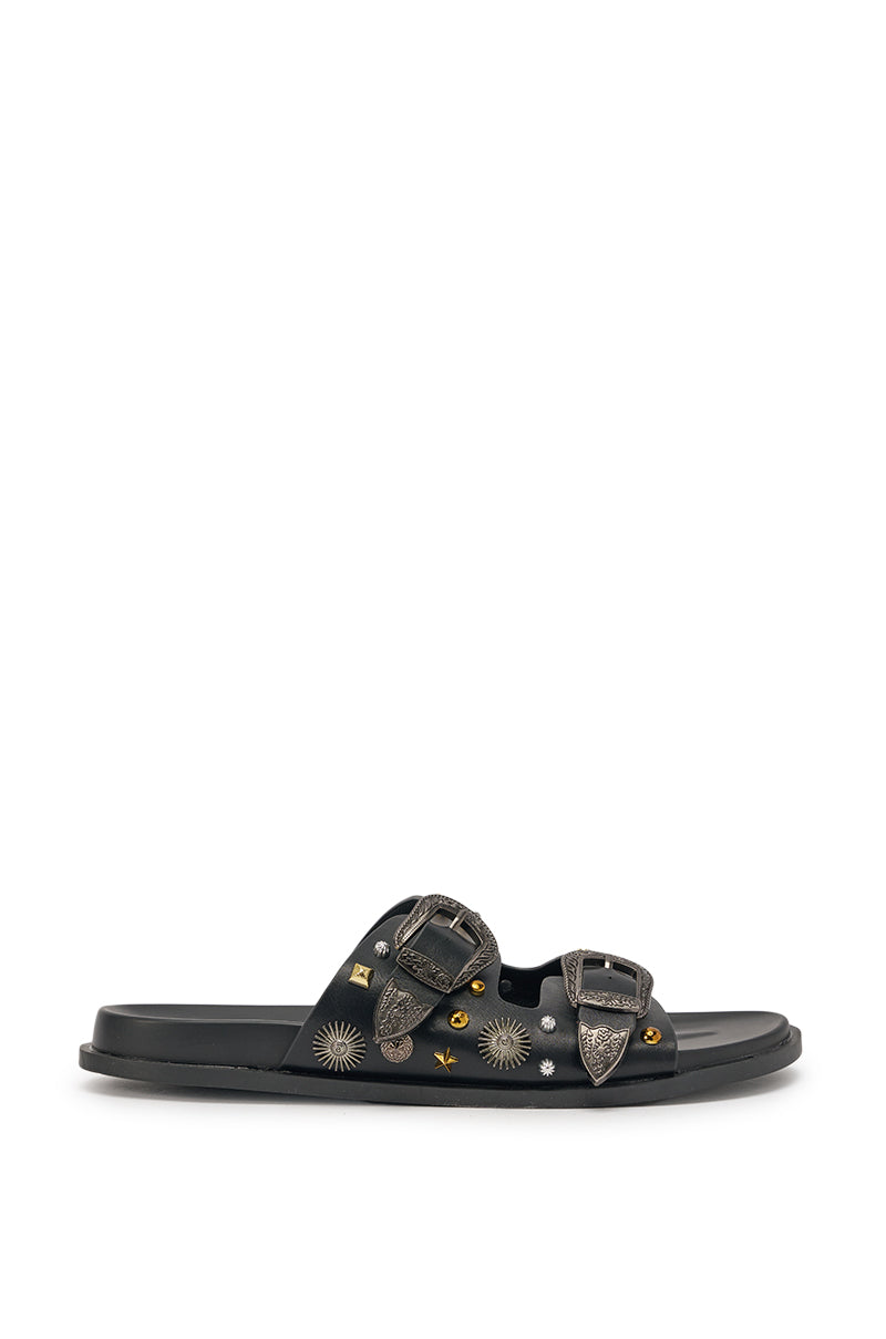 The AKIRA BARCLAY BLACK METAL EMBELLISHED SLIP ON FLAT SANDAL features black faux leather, two buckle straps, and silver and gold sunburst and star studs along the sides—a bold slide sandal that makes a statement. 4