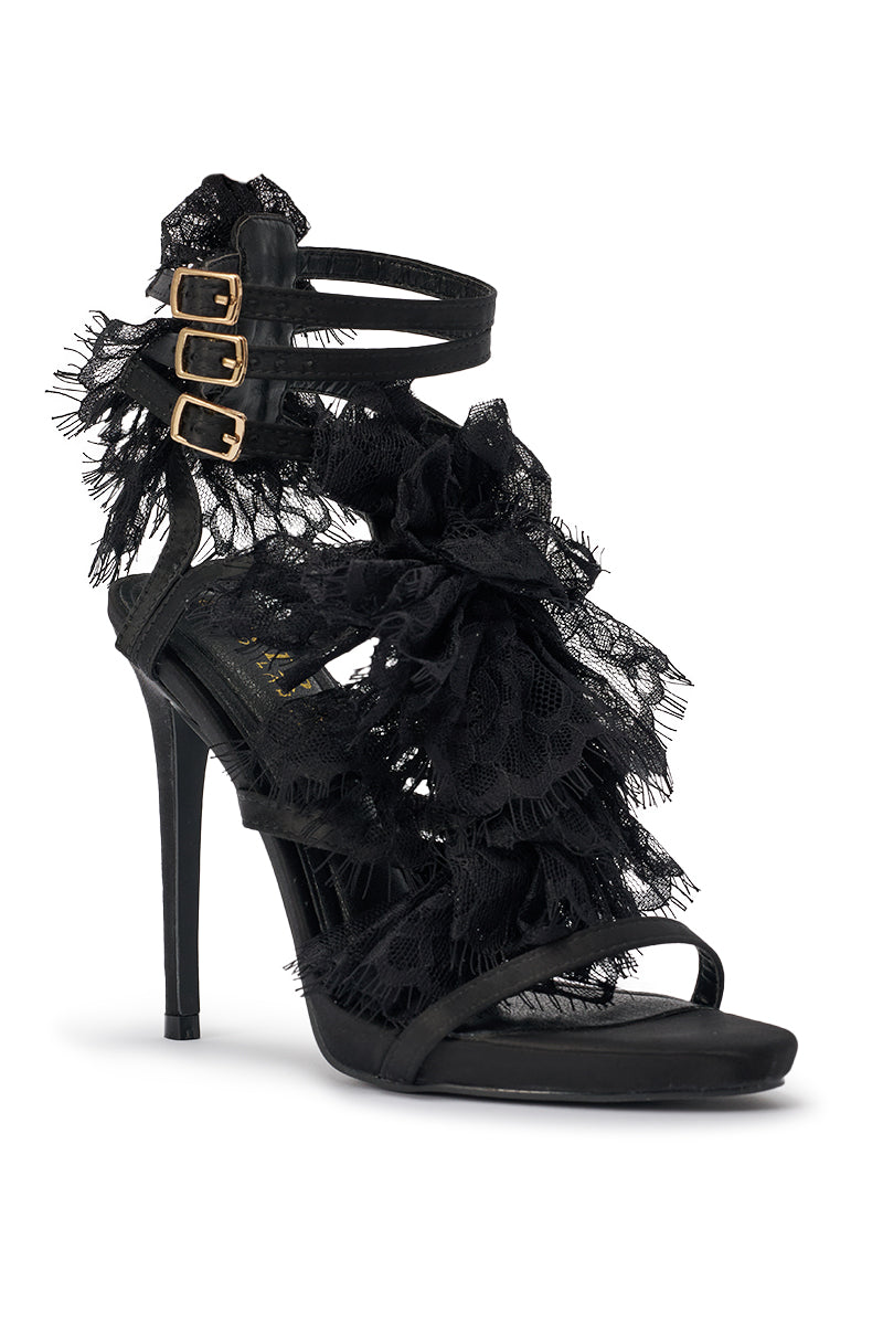 The AKIRA GOLD BARRISTER BLACK LACE DETAIL STILETTO SANDAL features black satin, open toes, three gold buckle ankle straps, and bold lace trim details on the straps and heel for an elegant, intricate look. 4