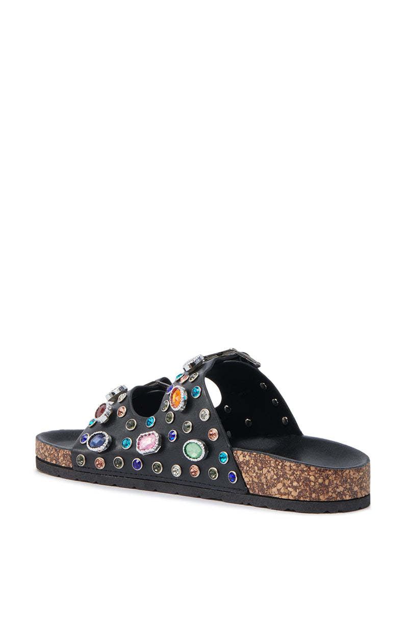 The AKIRA BAYLEAVES SLIP ON BLACK SANDAL features a black faux leather design with a cork sole and multicolored gemstone accents on the straps.
