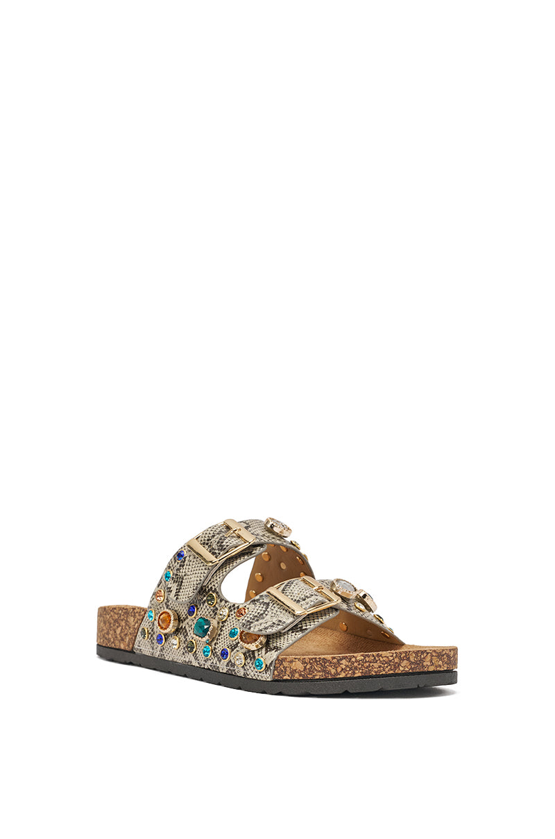 The AKIRA BAYLEAVES SNAKE EMBELLISHED FLAT SLIP ON SANDAL features a cork sole, two snakeskin-print straps with metallic studs and colorful gems, plus a black outer sole, displayed angled on a white background. 4