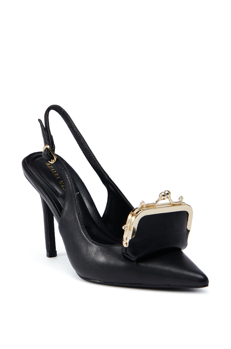Introducing the AZALEA WANG BAYLOR BLACK STILETTO PUMP: This exquisite high-heeled shoe boasts a distinctive design, highlighted by a small gold-framed miniature purse adorning the pointed toe. Made from faux leather, it seamlessly merges chic fashion with whimsical elegance, ensuring it stands out in any wardrobe.