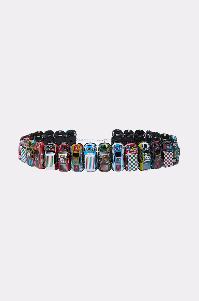 The FAST PACED CAR BELT is a playful streetwear accessory, featuring miniature, colorful race car charms linked in a circle against a plain white background.