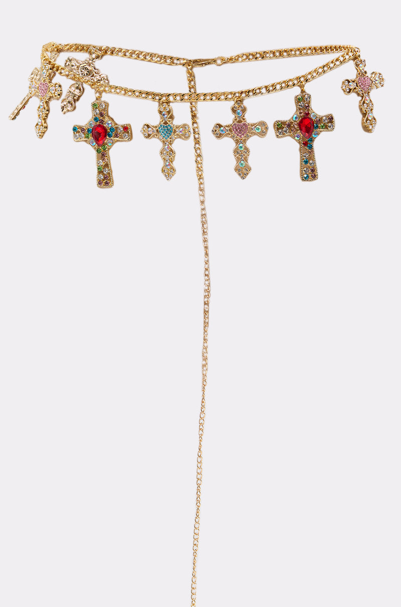 The IN MY FEELINGS CHAIN BELT features ornate cross pendants, sparkling rhinestones, colorful gemstones, and a long central chain, displayed on a plain white background. 3