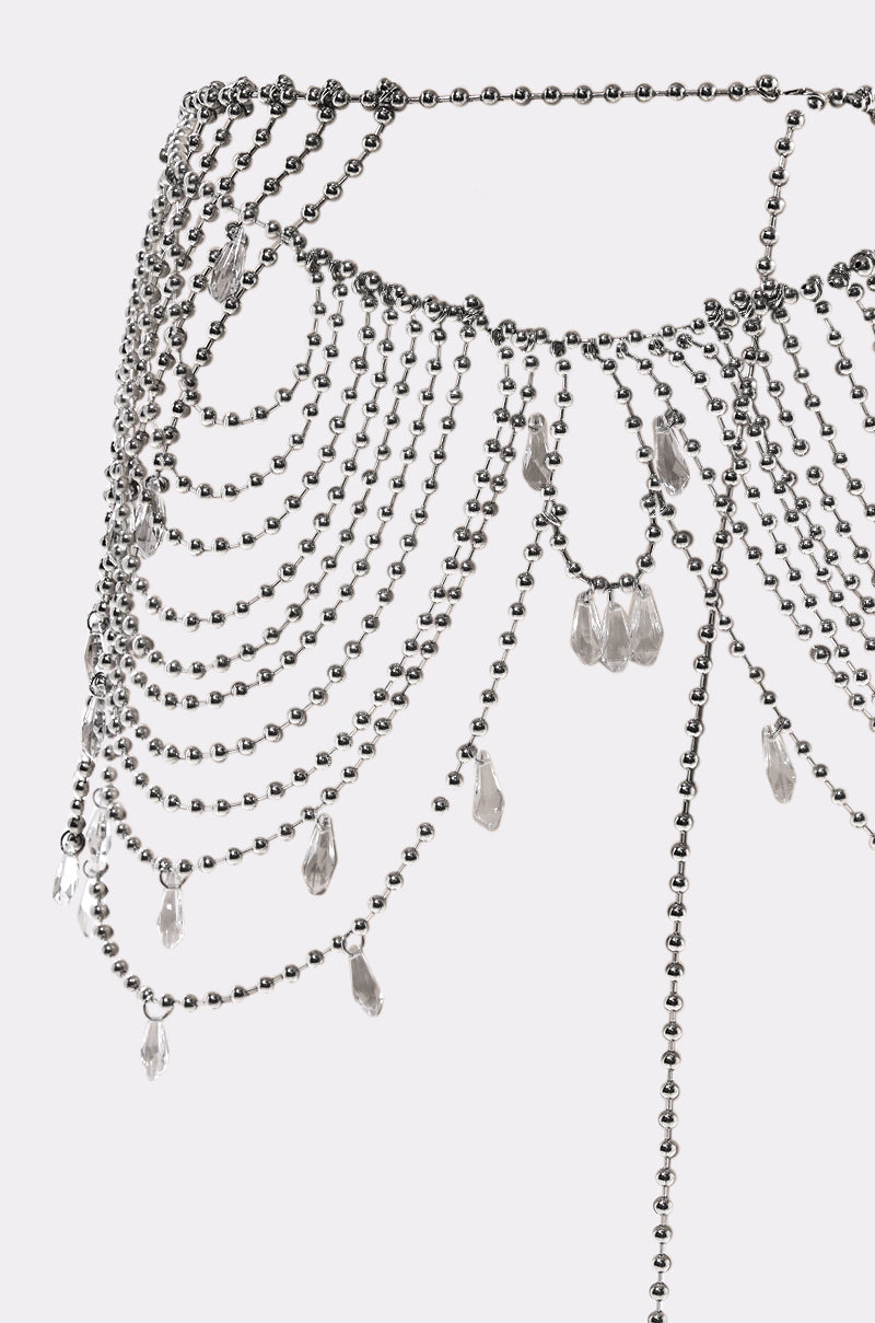 Close-up of the DRIPPIN CHAIN BELT, a silver-tone ball chain with cascading layers and dangling clear crystal charms, shown on a plain white background. 4