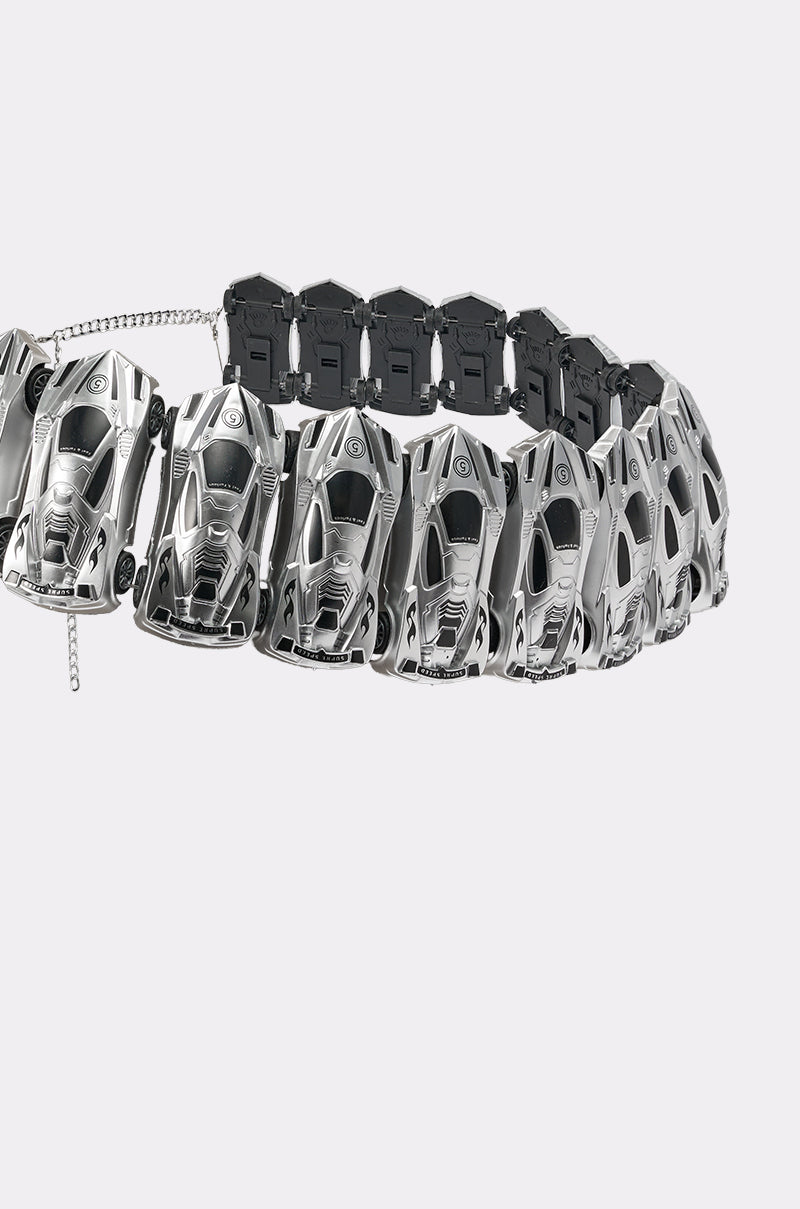 The VROOM VROOM CAR BELT is a silver chain necklace featuring miniature sports car-shaped links with a few darker ones at the back, set against a plain light gray background—ideal for Y2K accessory fans. 6