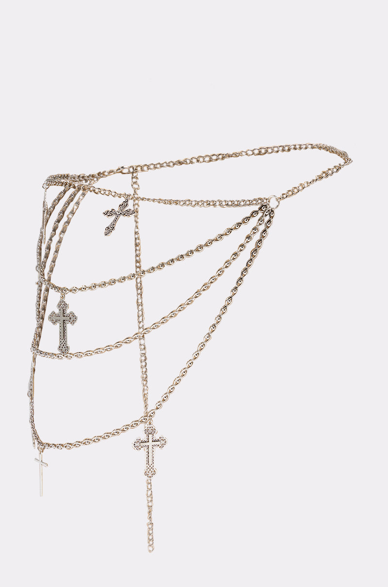 The ON HIS BOAT CHAIN BELT is a gold layered waist chain with multiple asymmetrical dangling cross pendants, perfect for making a bold statement with any festival belt look against a plain white background. 1