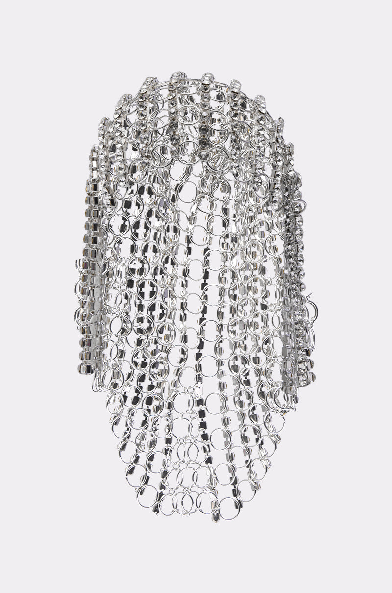 The QUEEN SH*T BLING HEADPIECE by AKIRA Label features interlocking silver metal rings and rhinestone chains, creating a shimmering mesh that drapes elegantly over the head and face.