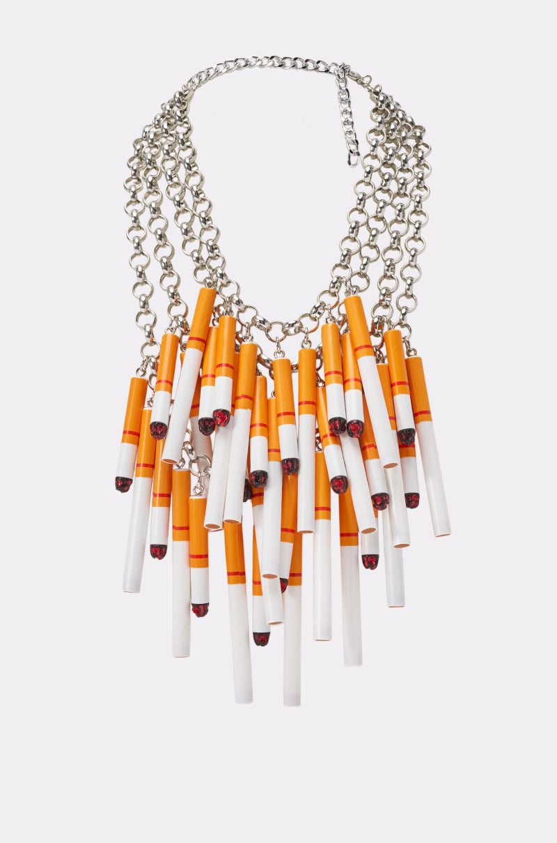 The CAN I LIGHT UP NECKLACE is a silver-tone layered chain necklace with realistic cigarette-shaped pendants, making it a bold statement piece for festivals and eye-catching looks.