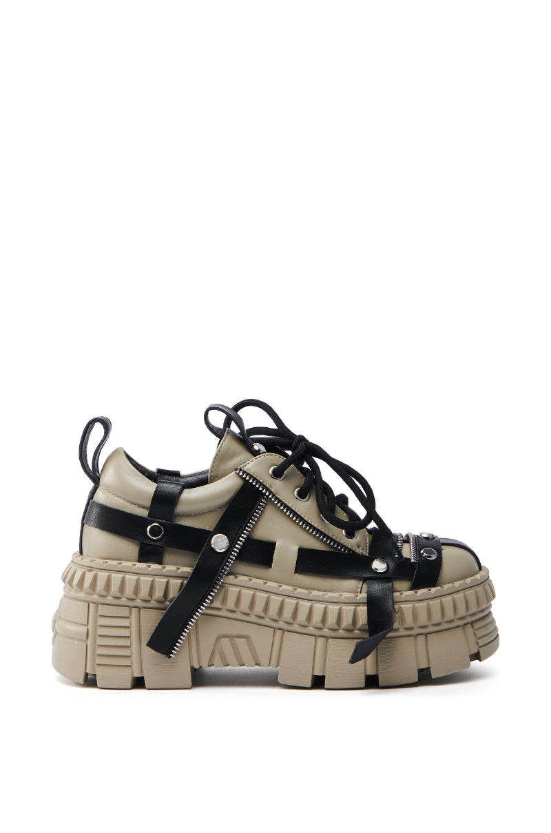 The AZALEA WANG BEAGLE KHAKI FLAT SNEAKER is a chunky flatform lug sole shoe with beige soles, black faux leather detailing, straps, buckles, and zippers. It features a rugged textured design and lace-up closure for an edgy urban appeal.